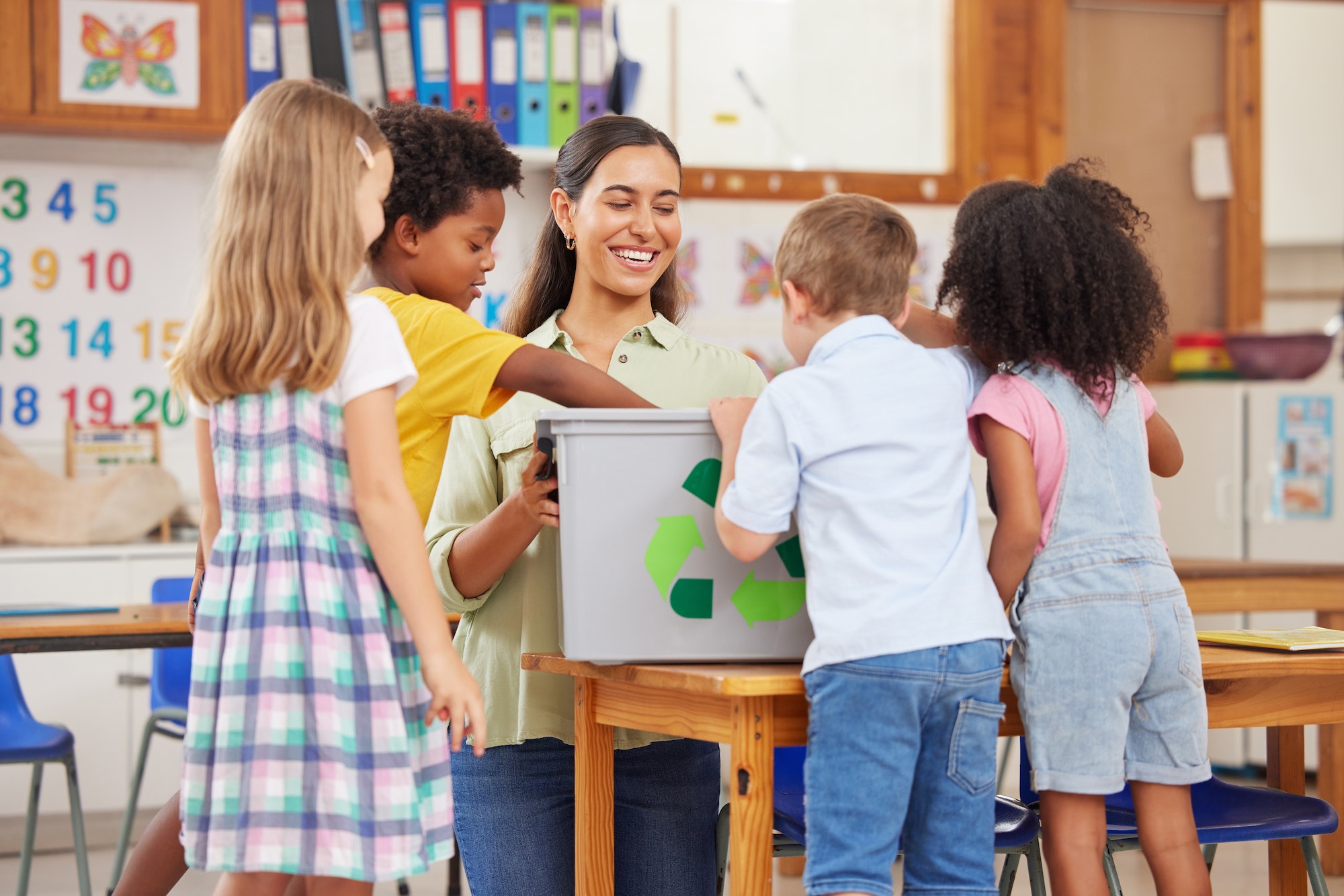 Theyre excited to learn. Shot of a young woman teaching preschool children about recycling.